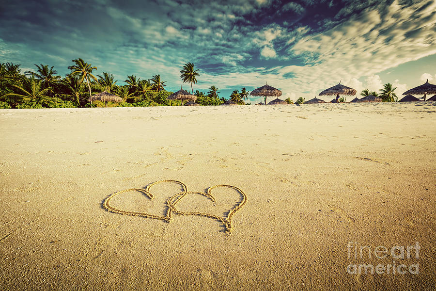 Two hearts drawn on sand of a tropical beach. Vintage Photograph by Michal Bednarek