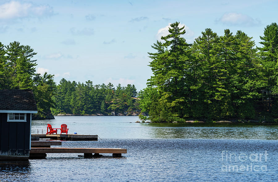Two red chairs on a dock Photograph by Les Palenik