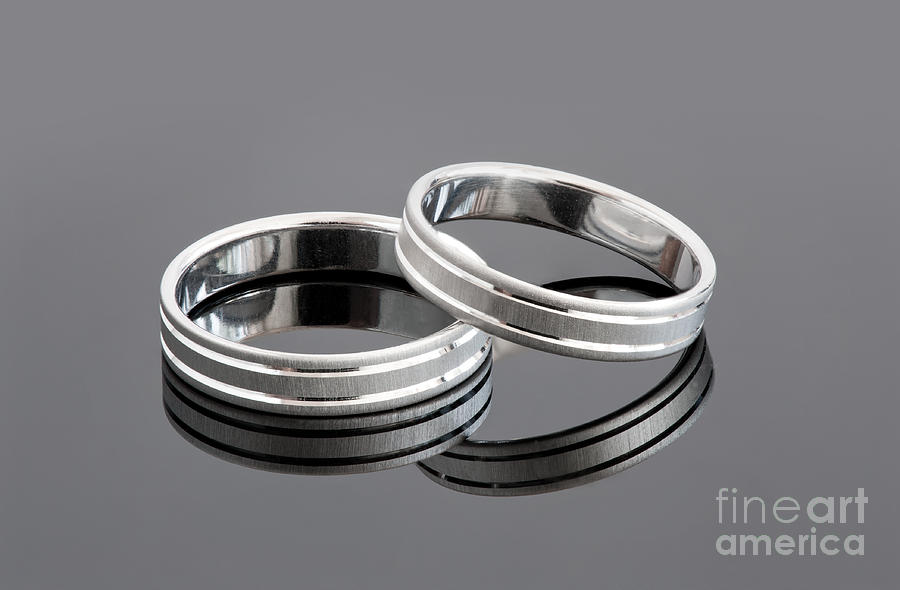 Two silver wedding rings Photograph by Arletta Cwalina