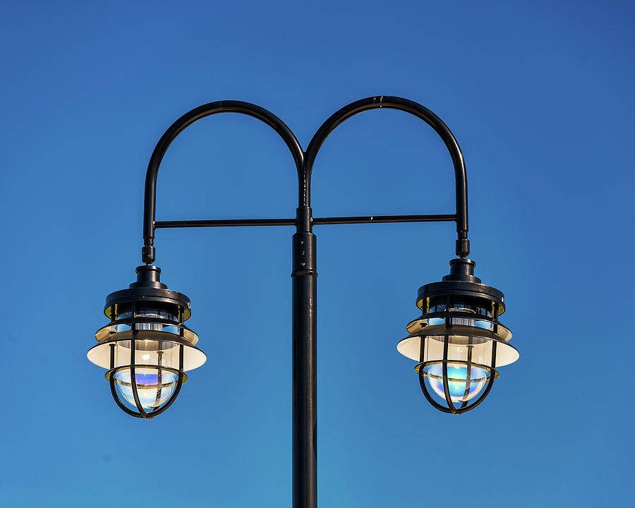 Two Streetlamps Against A Blue Sky Photograph by Gary Slawsky