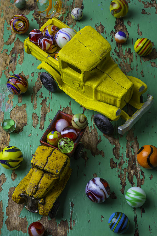 Two Toy Trucks With Marbles Photograph by Garry Gay