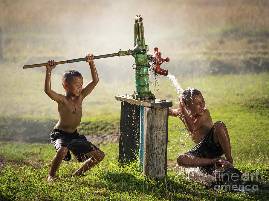 Nature Photograph - Two young boy rocking groundwater bathe in the hot days. by Tosporn Preede