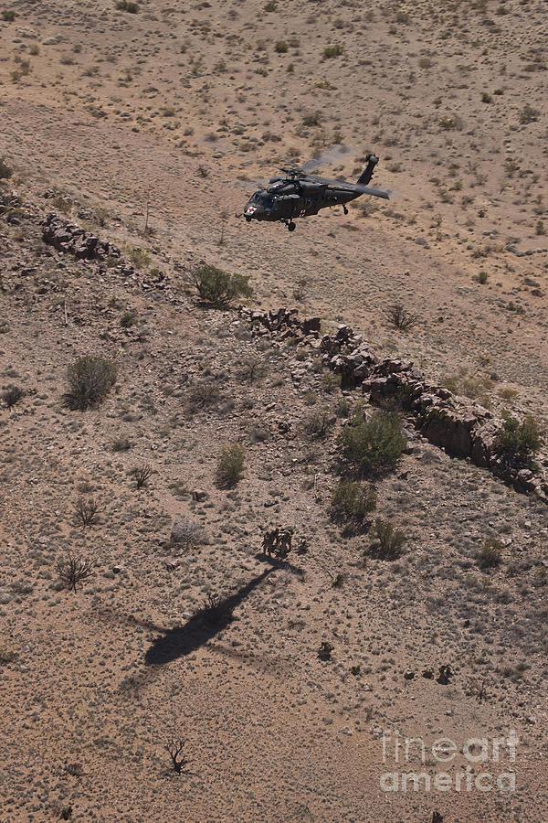 Uh-60 Black Hawk Hovers Above U.s Photograph by Terry Moore