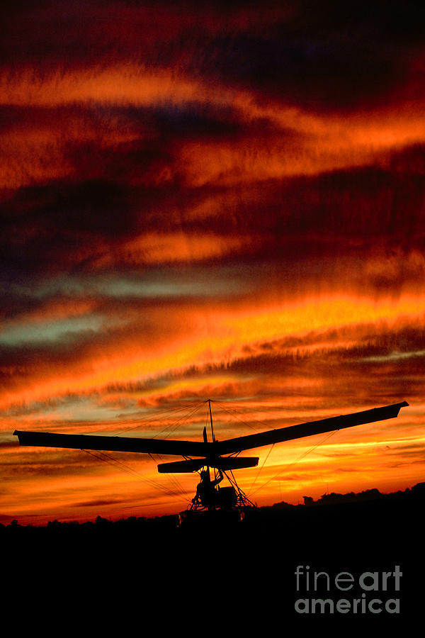 Ultralight into the Sunset Flying into the Sunset Clouds Photograph by Wernher Krutein