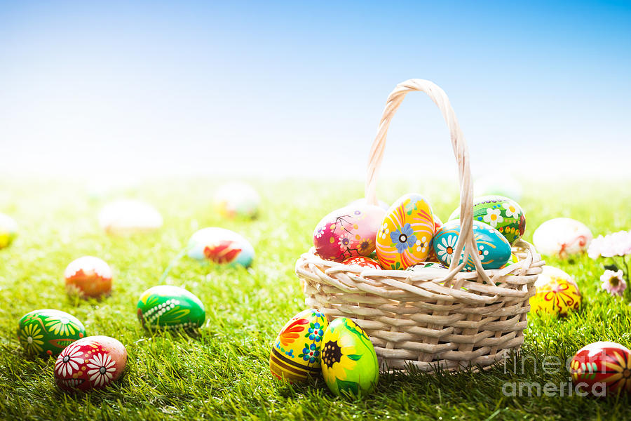 Unique hand painted Easter eggs in basket and lying on grass Photograph by Michal Bednarek