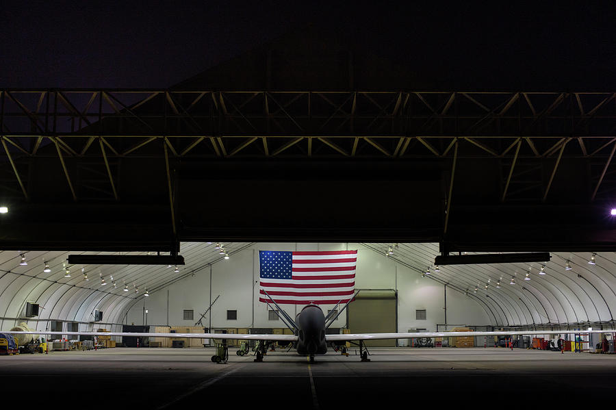 US Air Force EQ 4 Global Hawk assigned to the 380th Air Expeditionary Wing await routine Maintenance Photograph by Paul Fearn