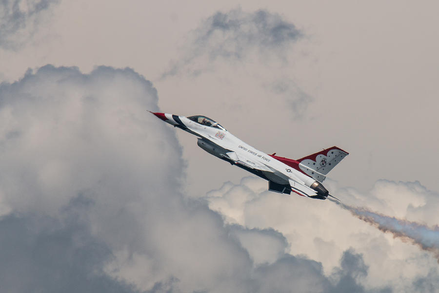 U.S. Air Force Thunderbirds Solo with Storm Clouds Behind Photograph by Tony Hake