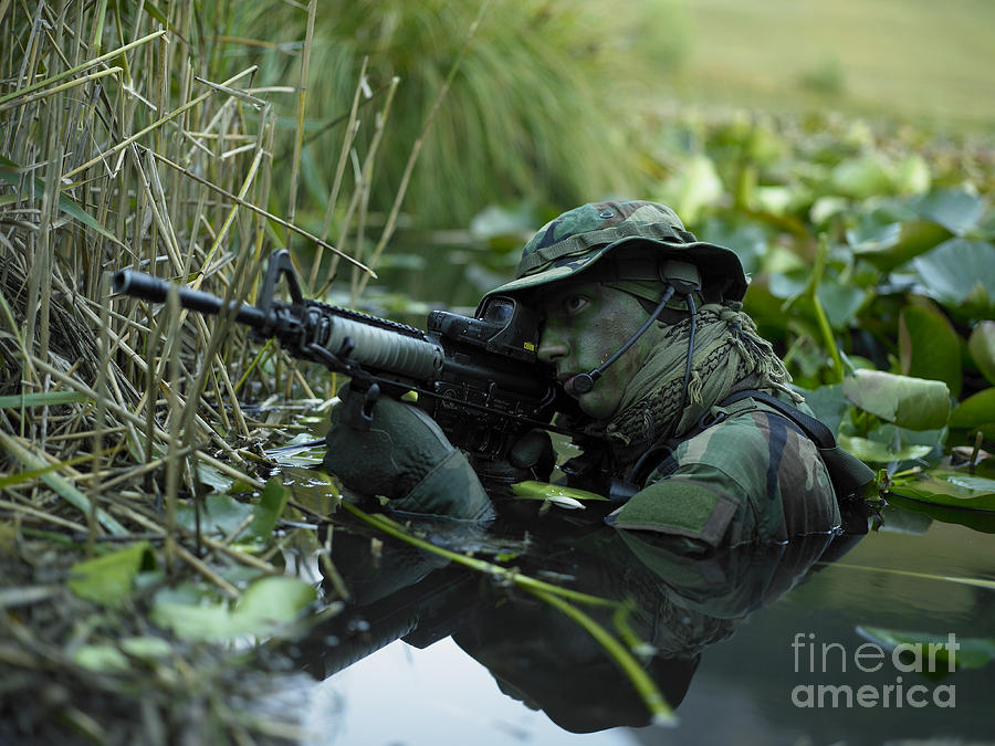 U.s. Navy Seal Crosses Through A Stream Photograph by Tom Weber