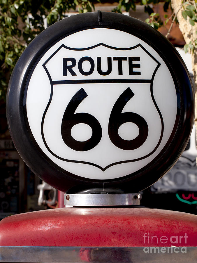US Route 66 road sign light on an old gas pump. Photograph by Anthony Totah