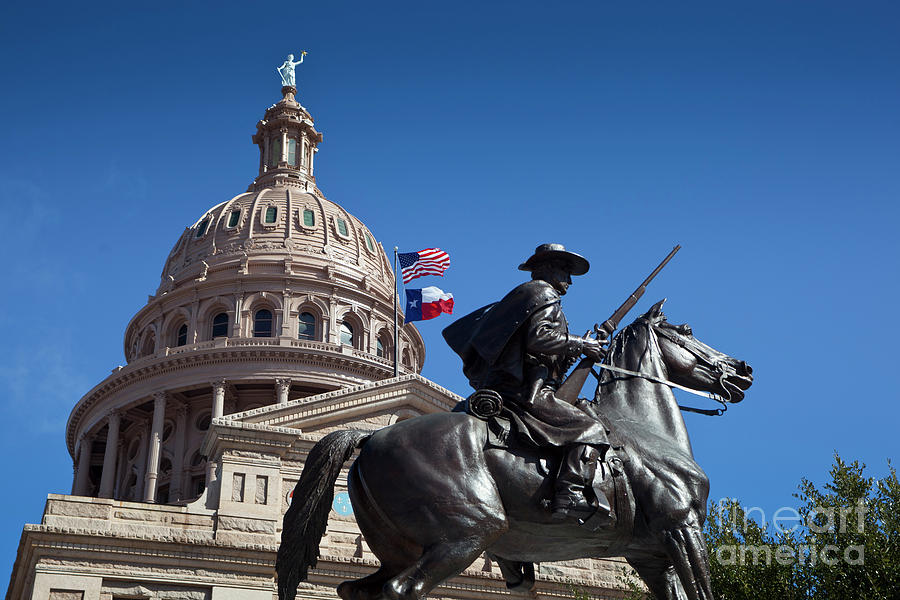 Texas Rangers Photograph - USA and Texas Flags fly next to the Texas Ranger statue at the Texas State Capitol by Dan Herron