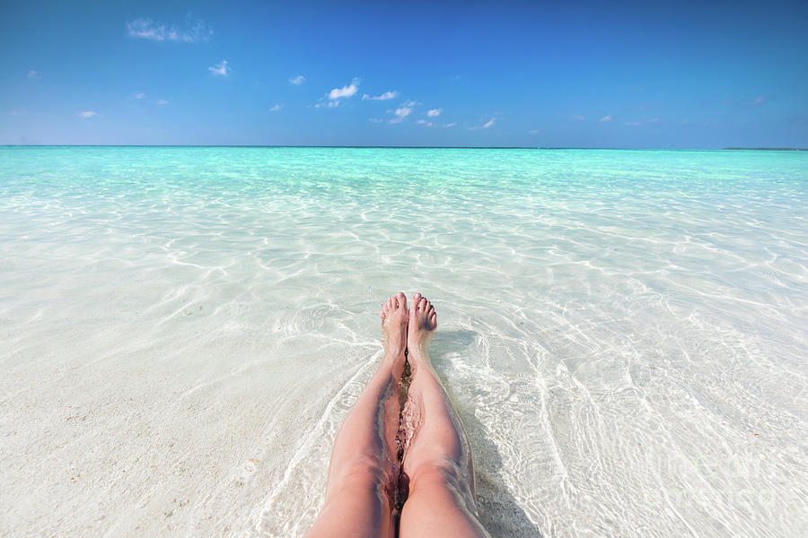 Vacation On Tropical Beach In Maldives Woman S Legs In The Clear Ocean