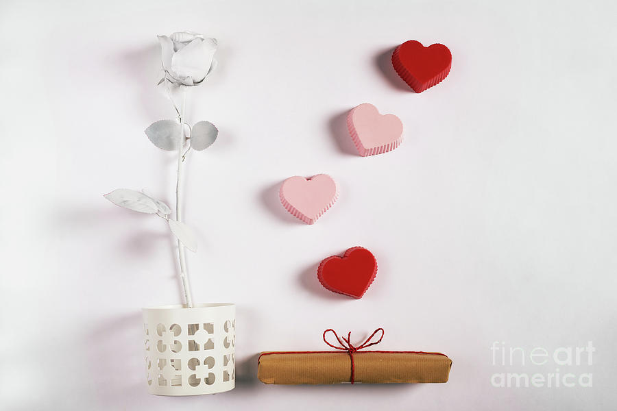 Valentine composition with rose, gift and hearts. Photograph by Michal Bednarek