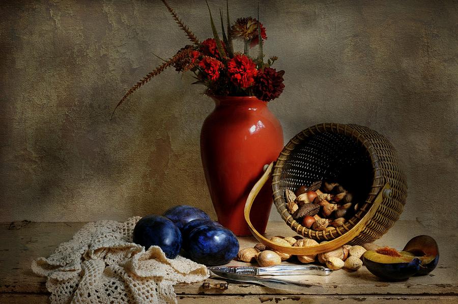 Vase with basket of walnuts Photograph by Diana Angstadt