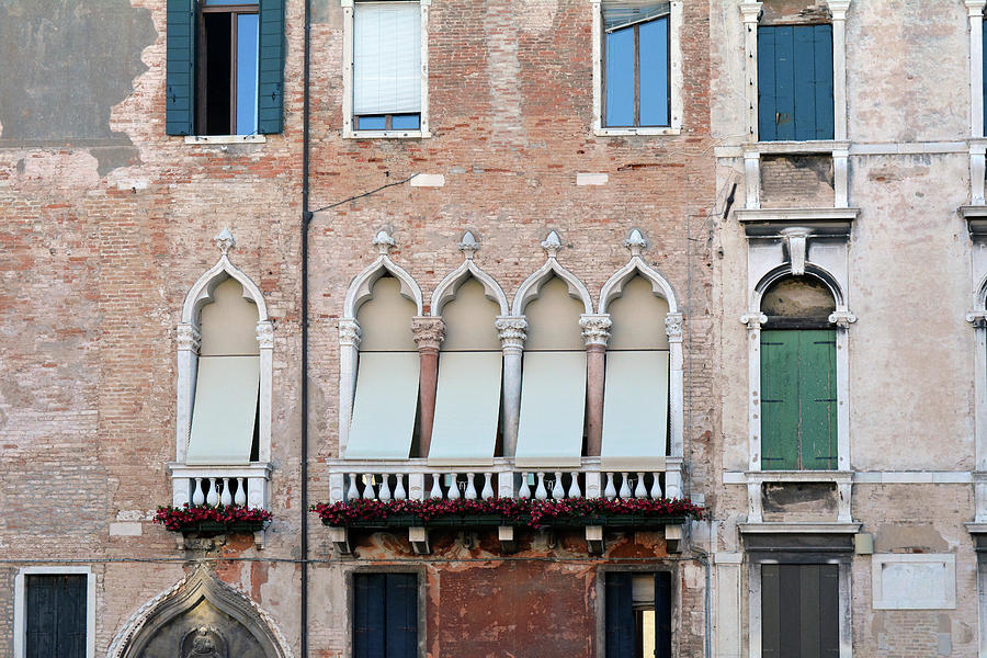 Venetian building facade with windows with arches and shutters ...