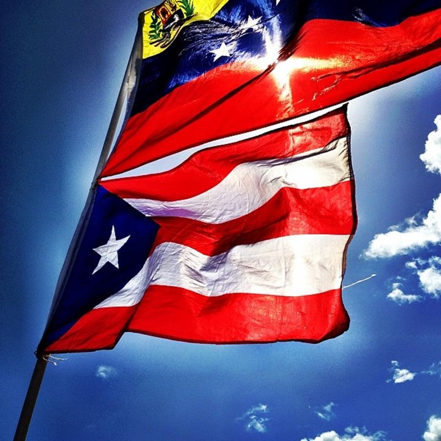 Venezuela And Puerto Rico Flags Against Photograph by Juan Silva