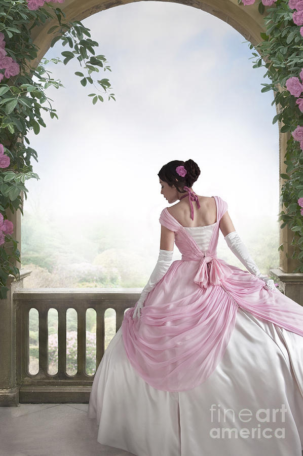 Victorian Woman In A Pink Ball Gown Beneath A Rose Arch Photograph by Lee Avison