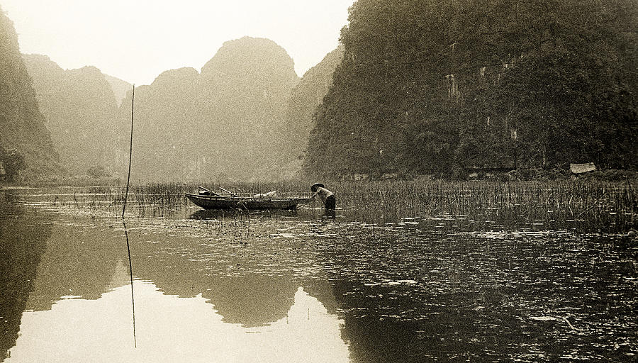 Vietnamese fisher on the river Tam Coc No4 Photograph by Weston Westmoreland