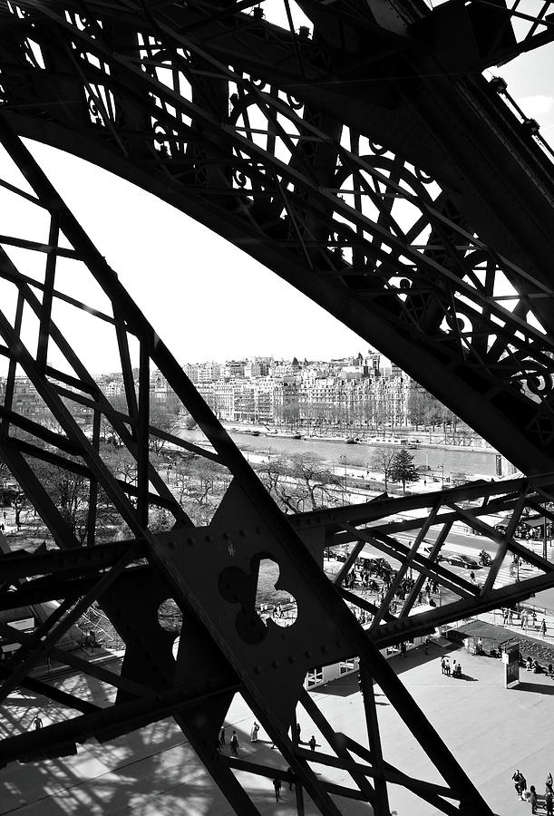 View of River Seine through the Iron Struts of the Eiffel Tower Paris France Black and White Photograph by Shawn OBrien