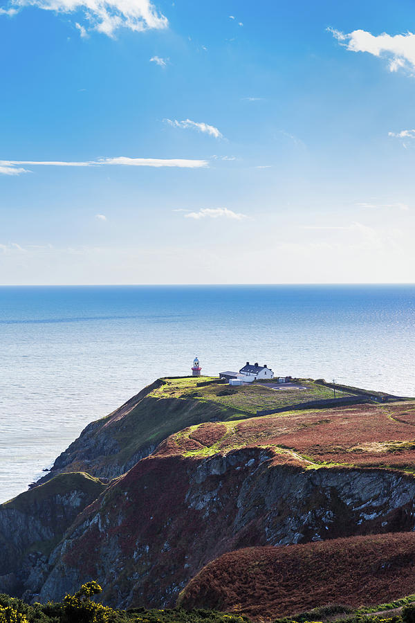 View of the trails on Howth Cliffs with the lighthouse in Irelan Photograph by Semmick Photo