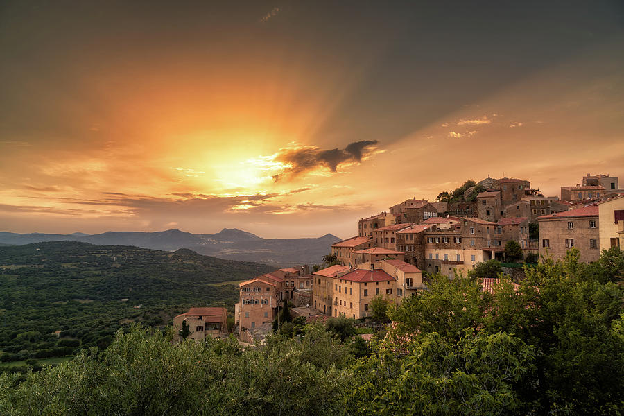 Village of Belgodere in Corsica lit by dramatic sunset Photograph by Jon Ingall