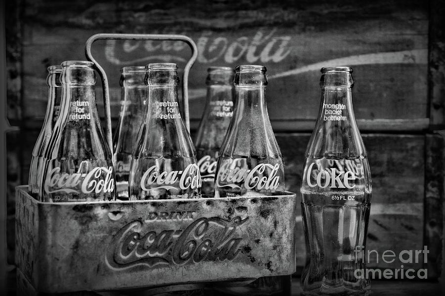 Vintage Photograph - Vintage Coca Cola Metal Carrier in black and white by Paul Ward