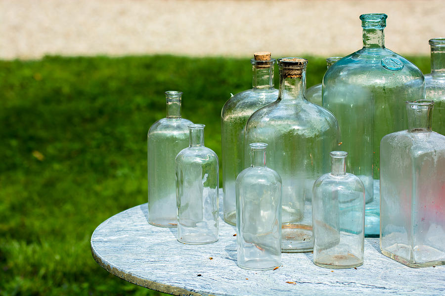 Vintage Glass Bottles On Table Photograph by Andreas Berthold