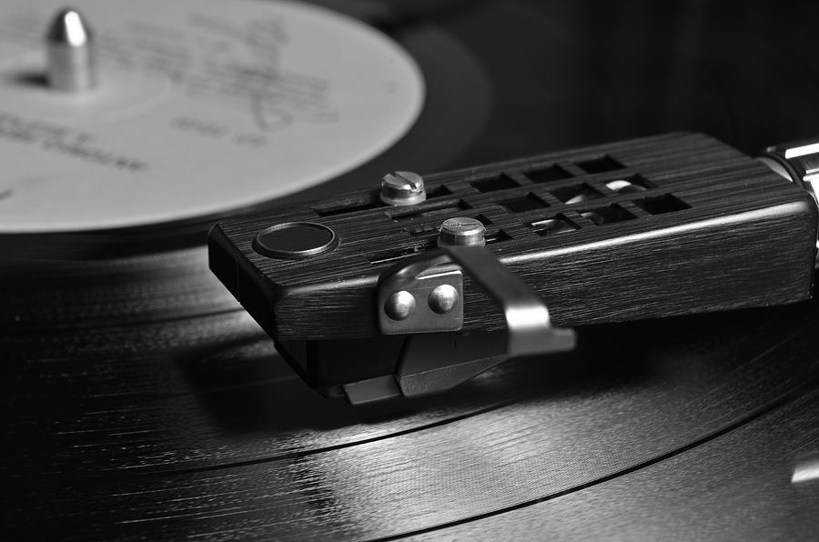 Vinyl record playing on a turntable in Monochrome Photograph by Angelo DeVal