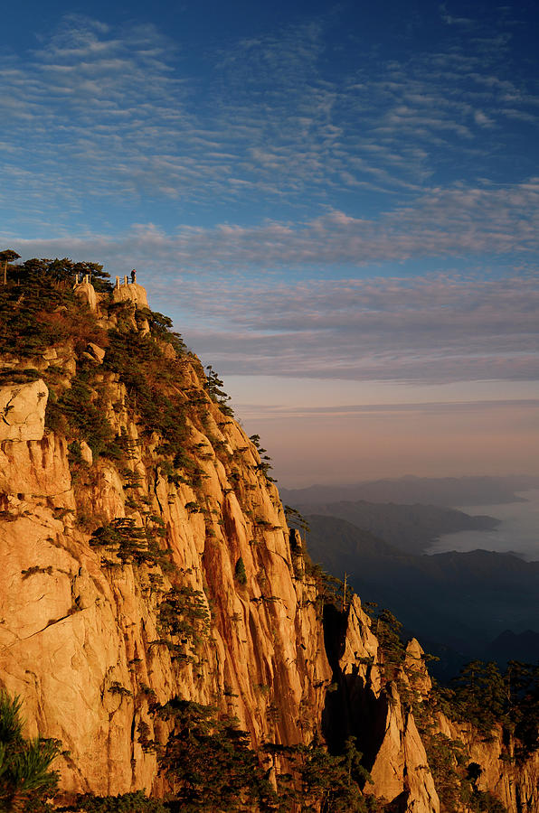 Visitor on Lion Peak at sunrise with fog in valley at Huangshan  Photograph by Reimar Gaertner