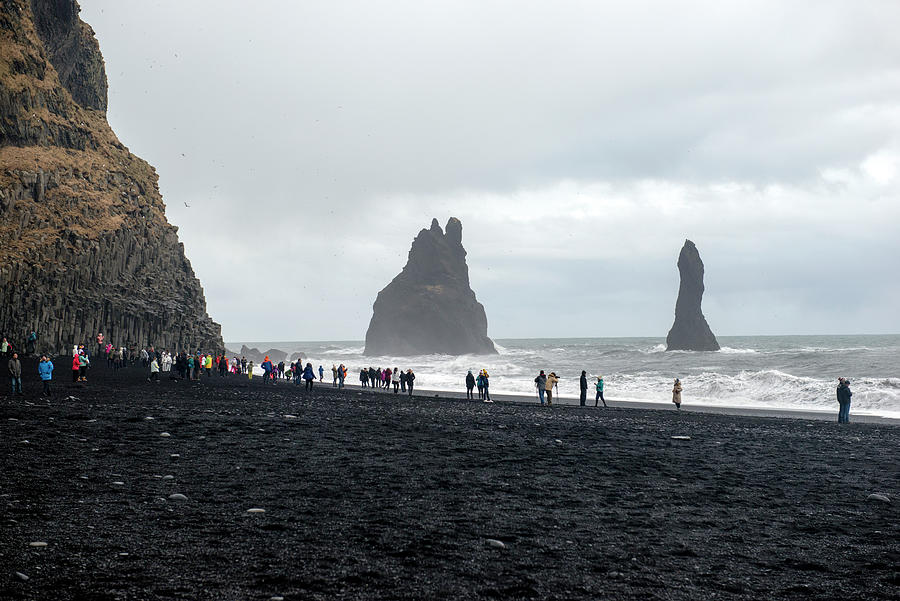 Winter Photograph - Visitors in Reynisfjara black sand beach, Iceland by Dubi Roman
