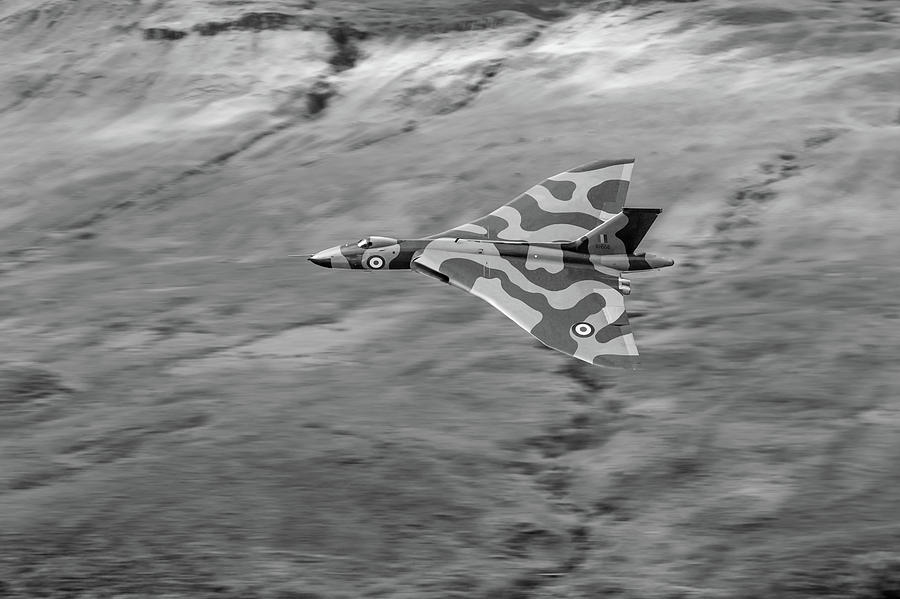 Vulcan low-level against hillside BW version Photograph by Gary Eason