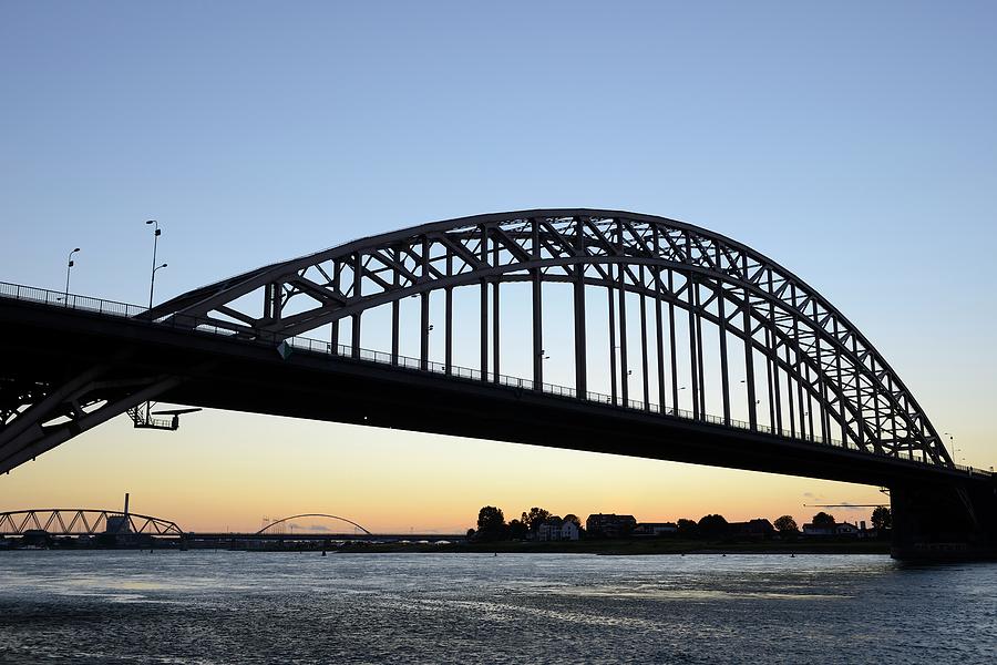 Waal Bridge over the Waal River in Nijmegen at sunset Photograph by Merijn Van der Vliet