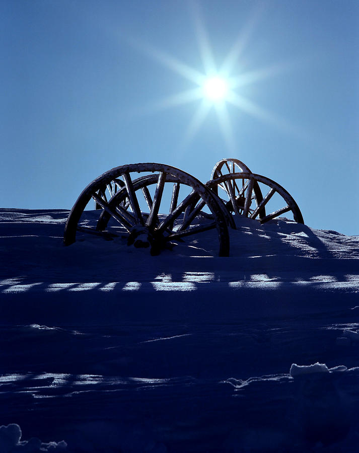 Wagon Wheels On Snow Photograph by Steve Lucas