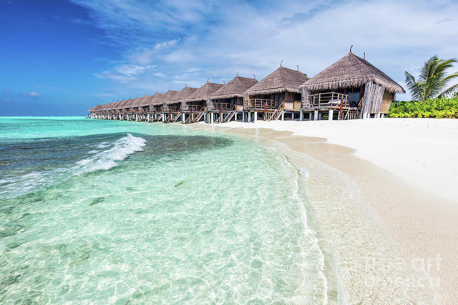 Water villas in a row by the seashore on Maldives Tropical resort Photograph by Michal Bednarek
