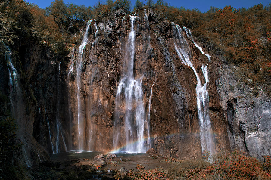 Waterfall and a rainbow Photograph by Jaroslaw Blaminsky