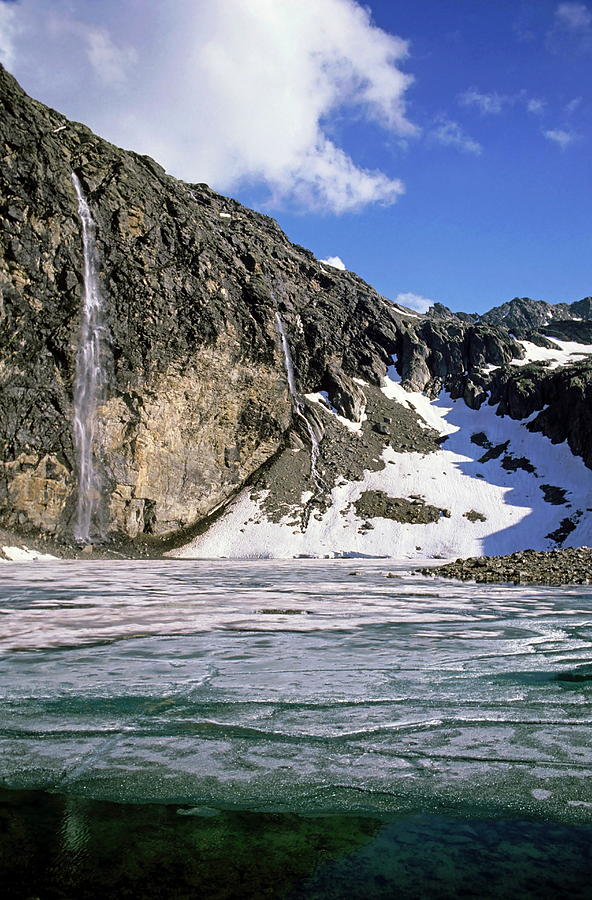 waterfalls-flowing-into-an-icy-lake-in-the-french-alps-photograph-by