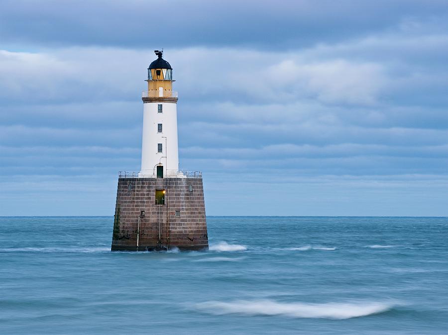 Waves and clouds at Rattray Head Lighthouse Photograph by Stephen Taylor
