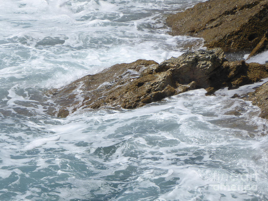 Waves lap rocky coast Photograph by Margaret Brooks