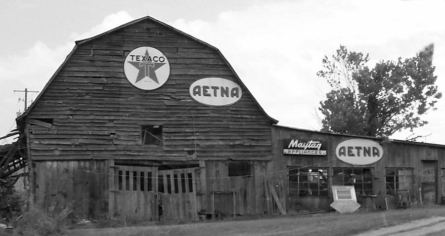 Weathered Dilapidated Store or Barn with Vintage Signage in Black and White Photograph by Ali Baucom
