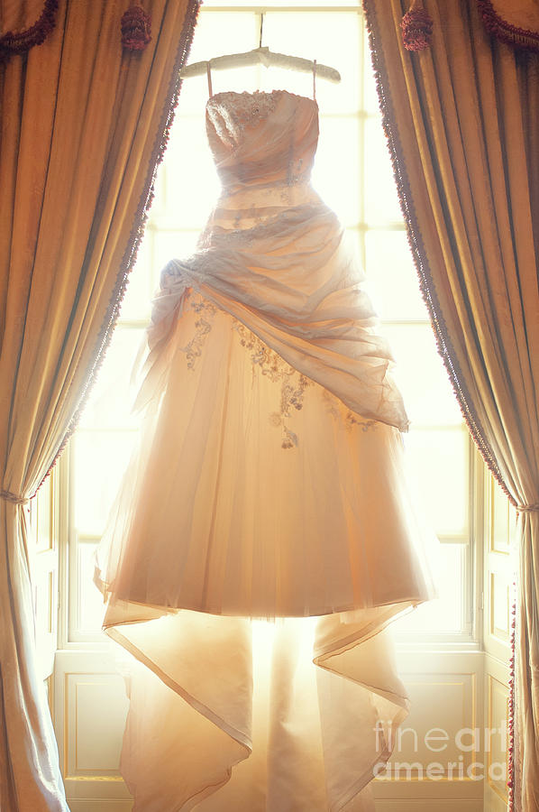 Wedding Dress Hanging In The Window Photograph by Lee Avison