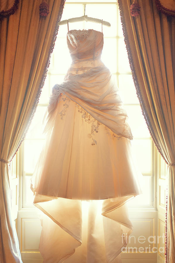 Wedding Dress Hanging In The Window by Lee Avison