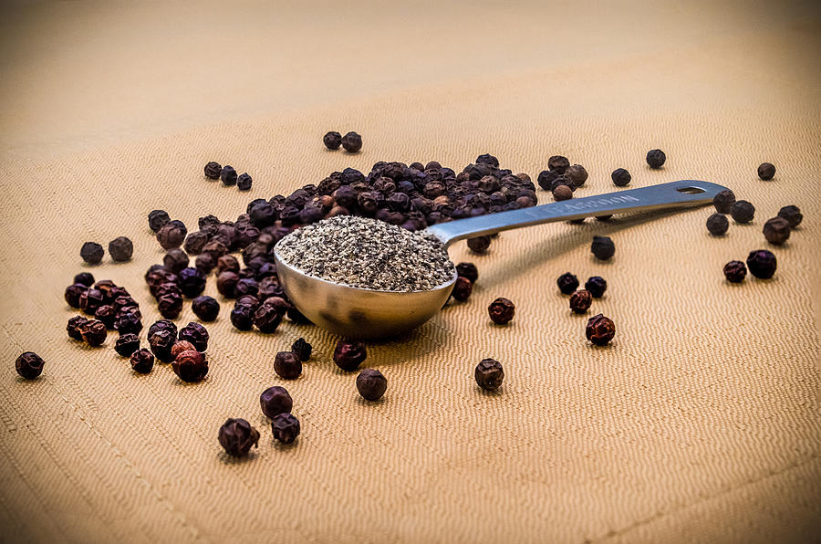 Spoon Still Life Photograph - Whole Black Peppercorns With a Heaping Teaspoon of Ground Pepper by Ray Sheley