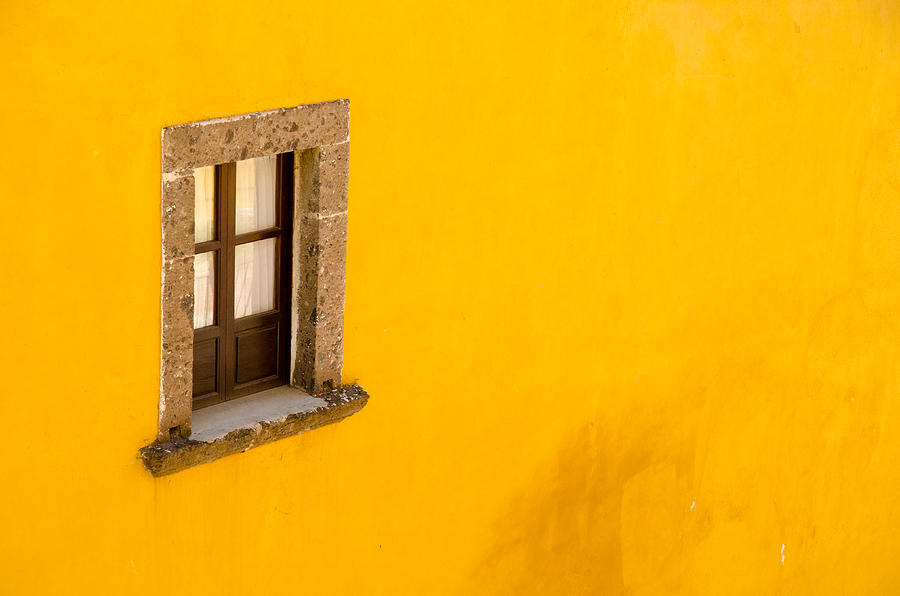 Window on a yellow wall. Photograph by Rob Huntley