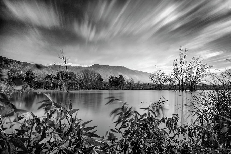 Black And White Photograph - Windy clouds at the lagoon by Guido Montanes Castillo