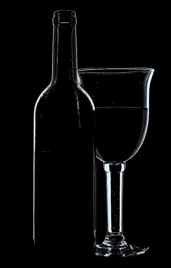Wine glass and bottle - mono with cool tones. Photograph by John Paul Cullen