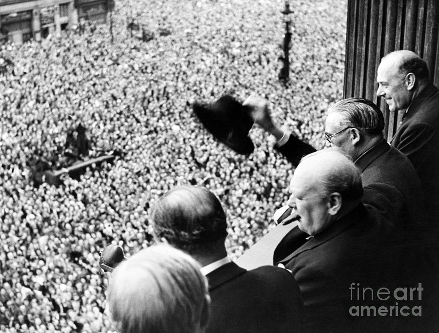 Winston Churchill looking out over crowds celebrating the end of the Second World War Photograph by English School