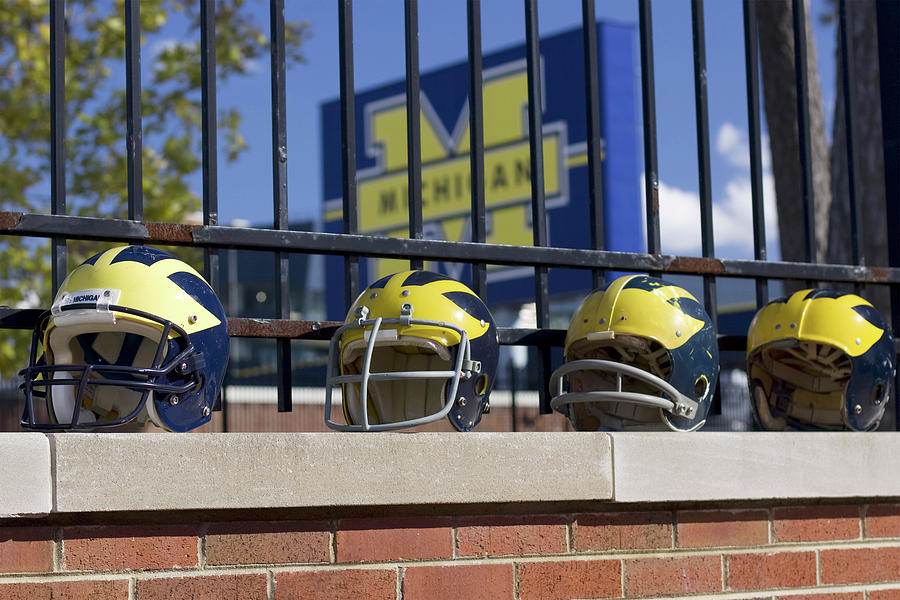 Wolverine Helmets of Different Eras on Stadium Wall by Michigan Helmet Wolverine Helmets of Different Eras on Stadium Wall by Michigan Helmet