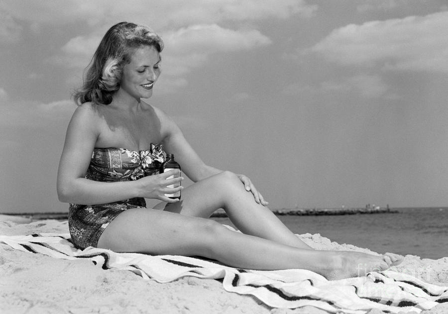Woman Applying Suntan Lotion, C.1950s Photograph by H Armstrong Roberts and ClassicStock