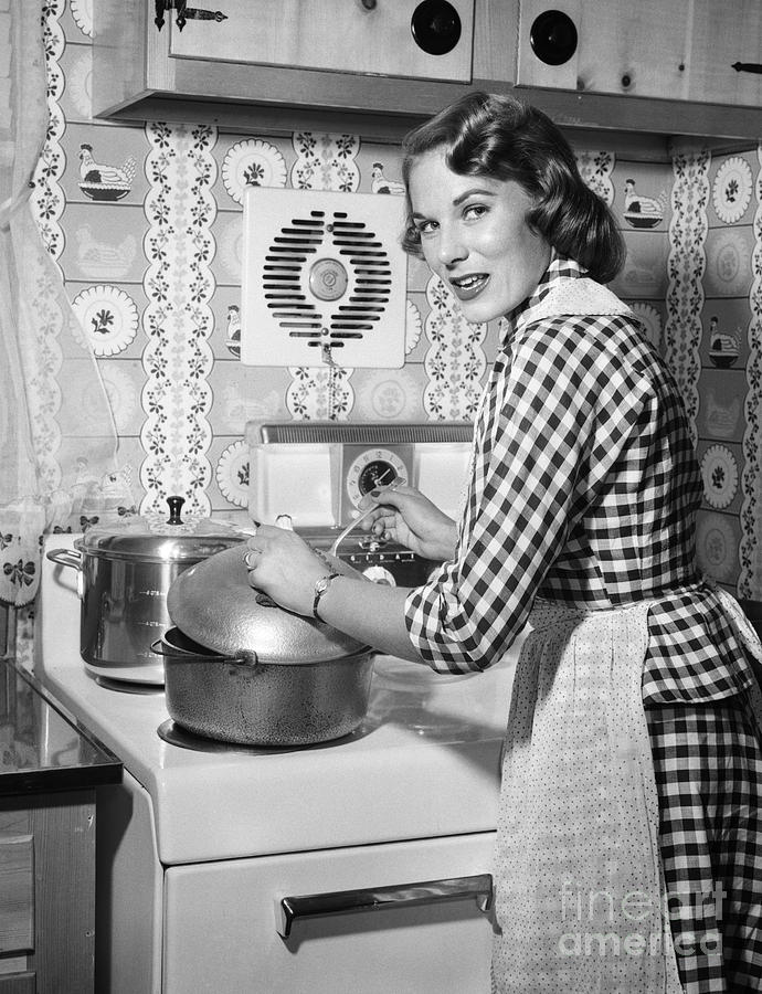 Woman Cooking On Stove, C.1950s Photograph by Debrocke/ClassicStock