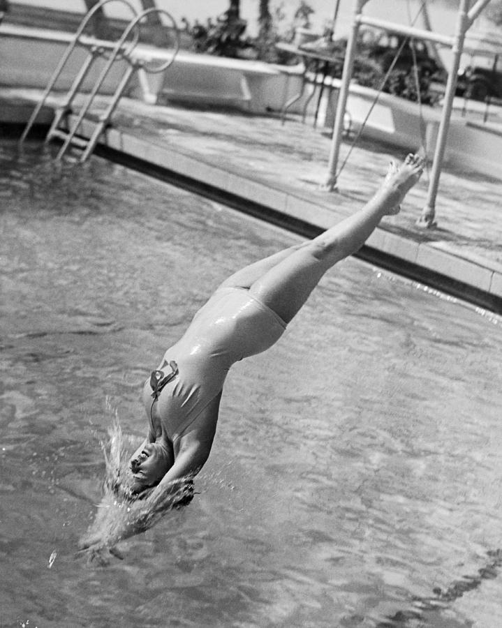 Woman Doing A Back Dive Photograph by Underwood Archives
