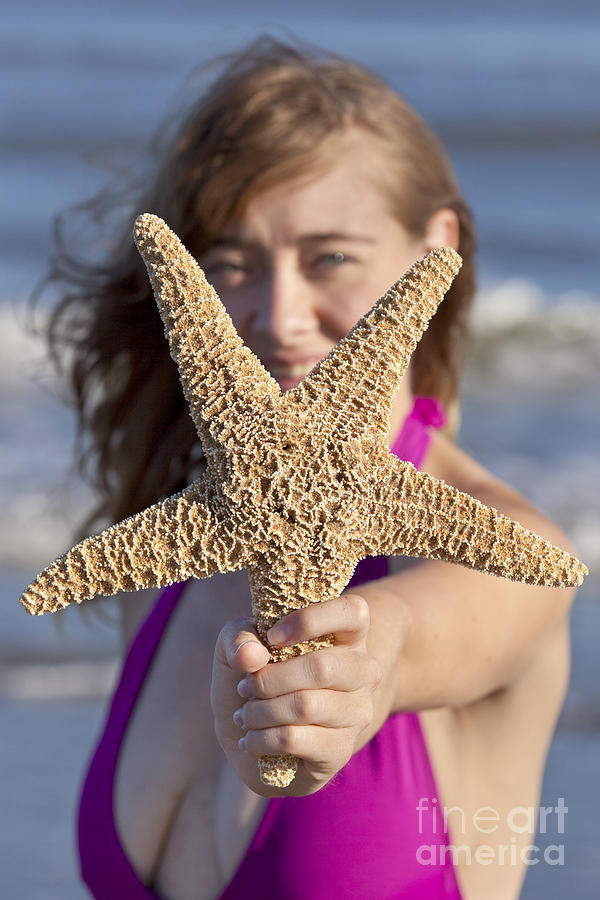 Woman holding a starfish Photograph by Anthony Totah